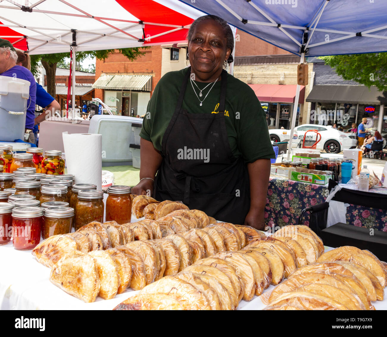 McDonough, May 18, 2019 A food vendor stands behind her