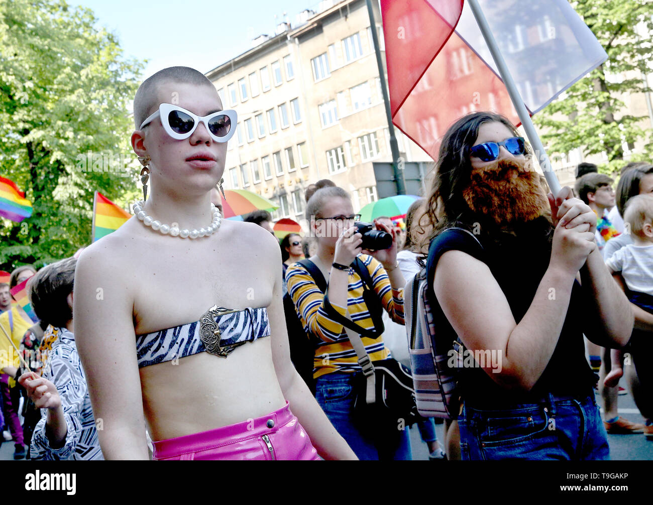 People are seen during the Equality March in Krakow. LGBT people and their supporters walk through the streets of Krakow to celebrate diversity and tolerance and express their opposition to discrimination and exclusion. The march was met in the city center by anti LGBT protesters from the far right organizations. Stock Photo