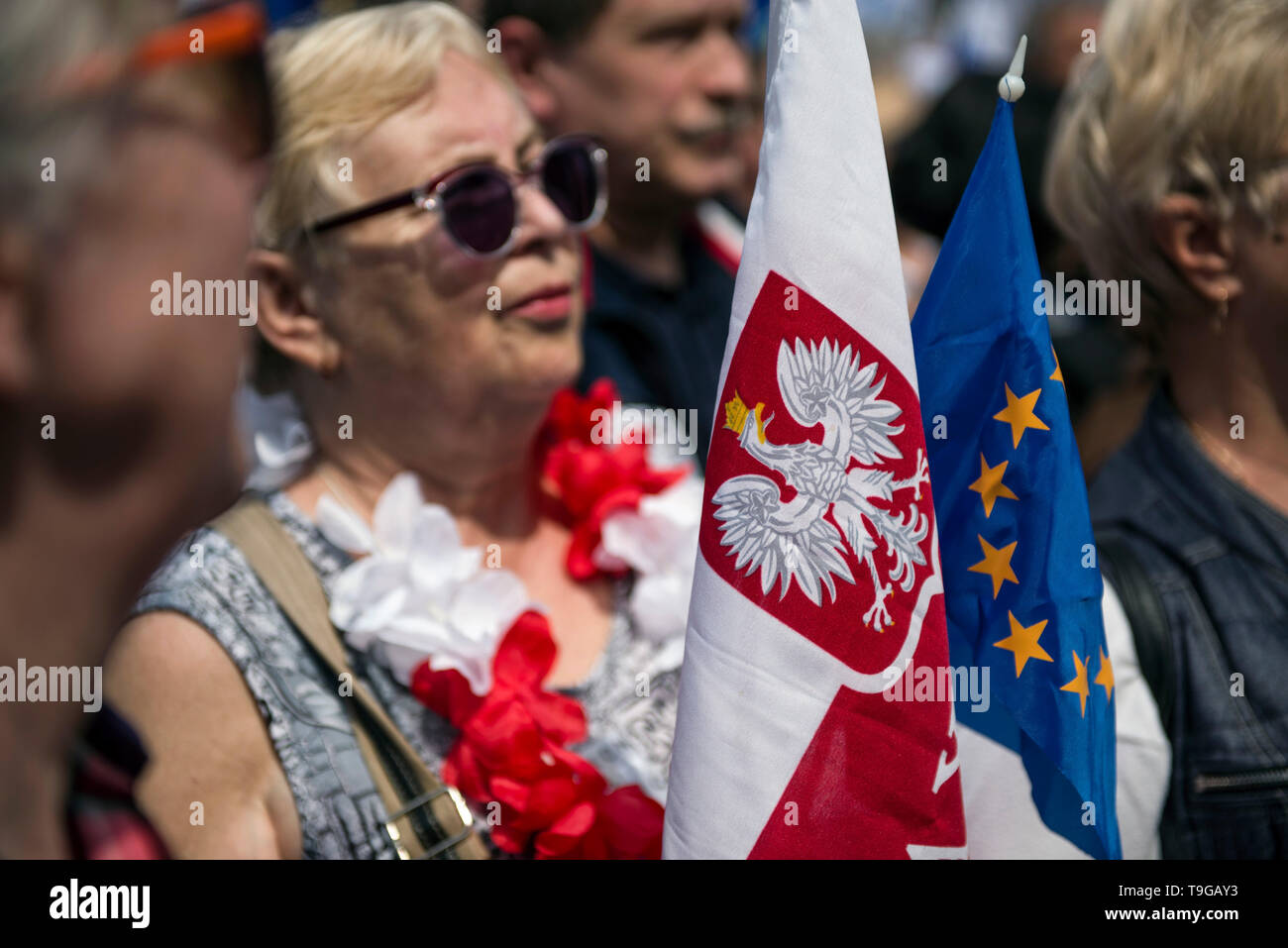 People seen with EU and Polish flags during the march. The march 'Poland in Europe' (Polska w Europie), was organized by the European Coalition (Koalicja Europejska) an alliance of political parties. The march was led by the leaders of the opposition parties and the President of the European Council, Donald Tusk. Unofficially, the March for Europe gathered about 45 thousand people. Stock Photo