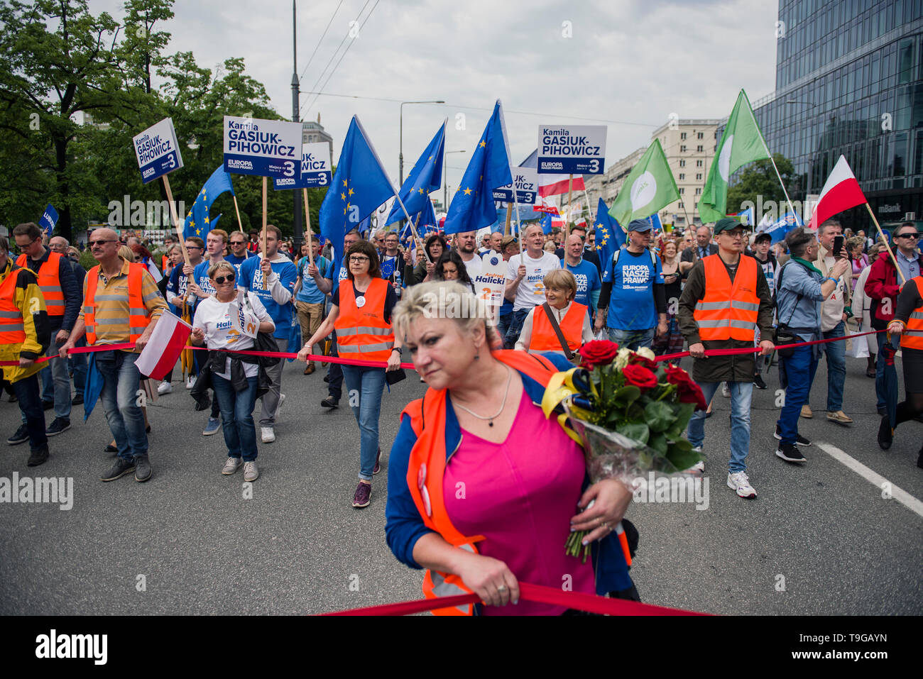 A woman is seen with flowers during the march. The march 'Poland in Europe' (Polska w Europie), was organized by the European Coalition (Koalicja Europejska) an alliance of political parties. The march was led by the leaders of the opposition parties and the President of the European Council, Donald Tusk. Unofficially, the March for Europe gathered about 45 thousand people. Stock Photo