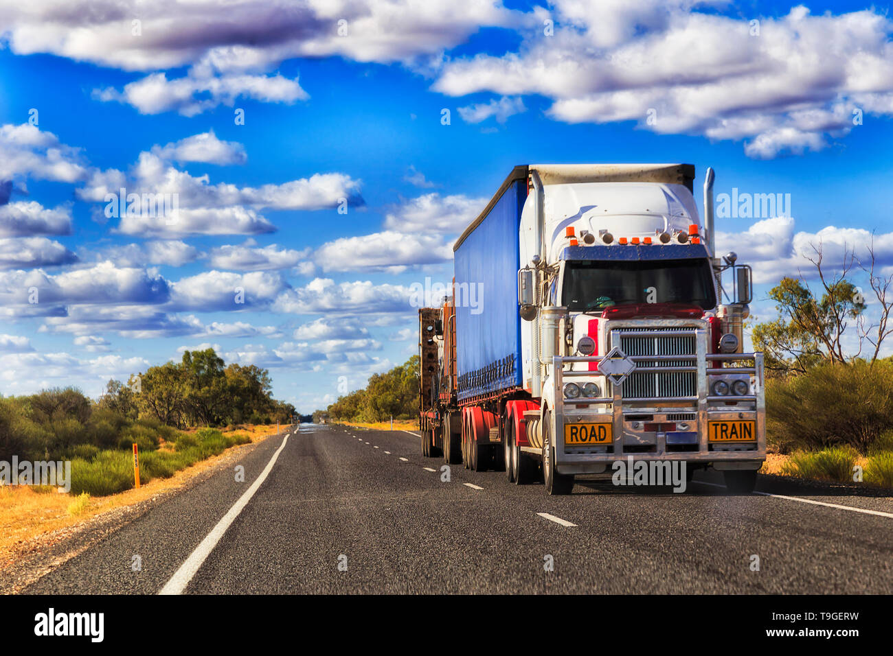 Long mighty road train truck moving cargo across Australia on a remote lonely empty outback highway in rural NSW. Stock Photo