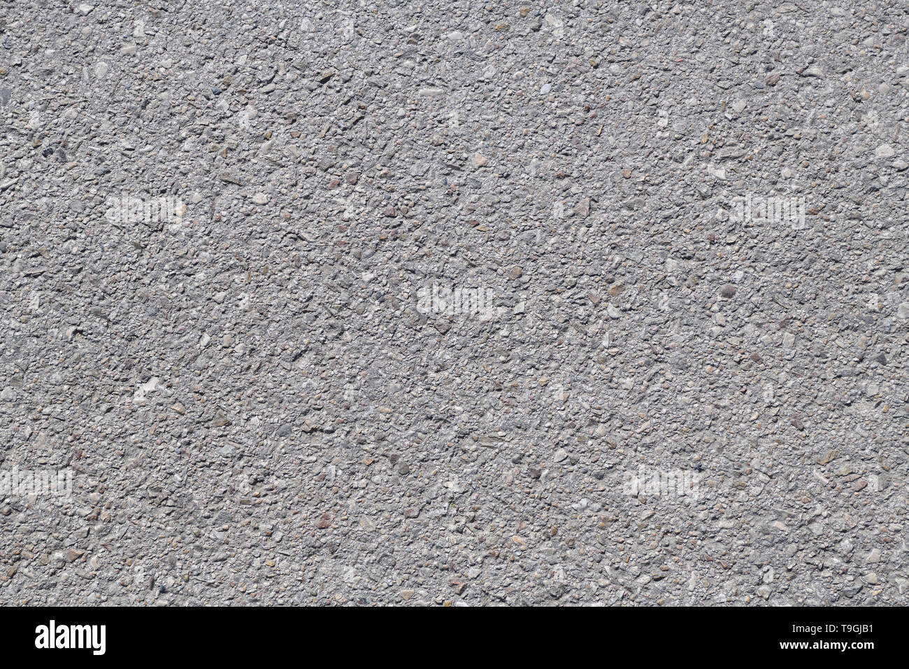 Asphalt background texture with some fine grain under the sun Stock Photo
