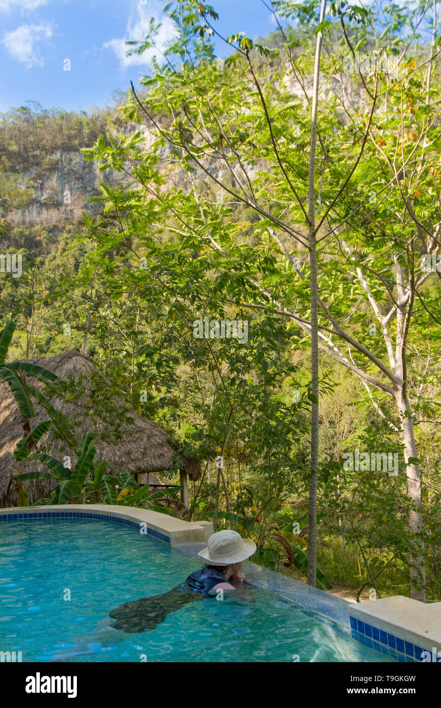 Woman in Spring fed pool, Black Rock Lodge, on Macal Riiver, San Ignacio, Cayo District, Belize Stock Photo