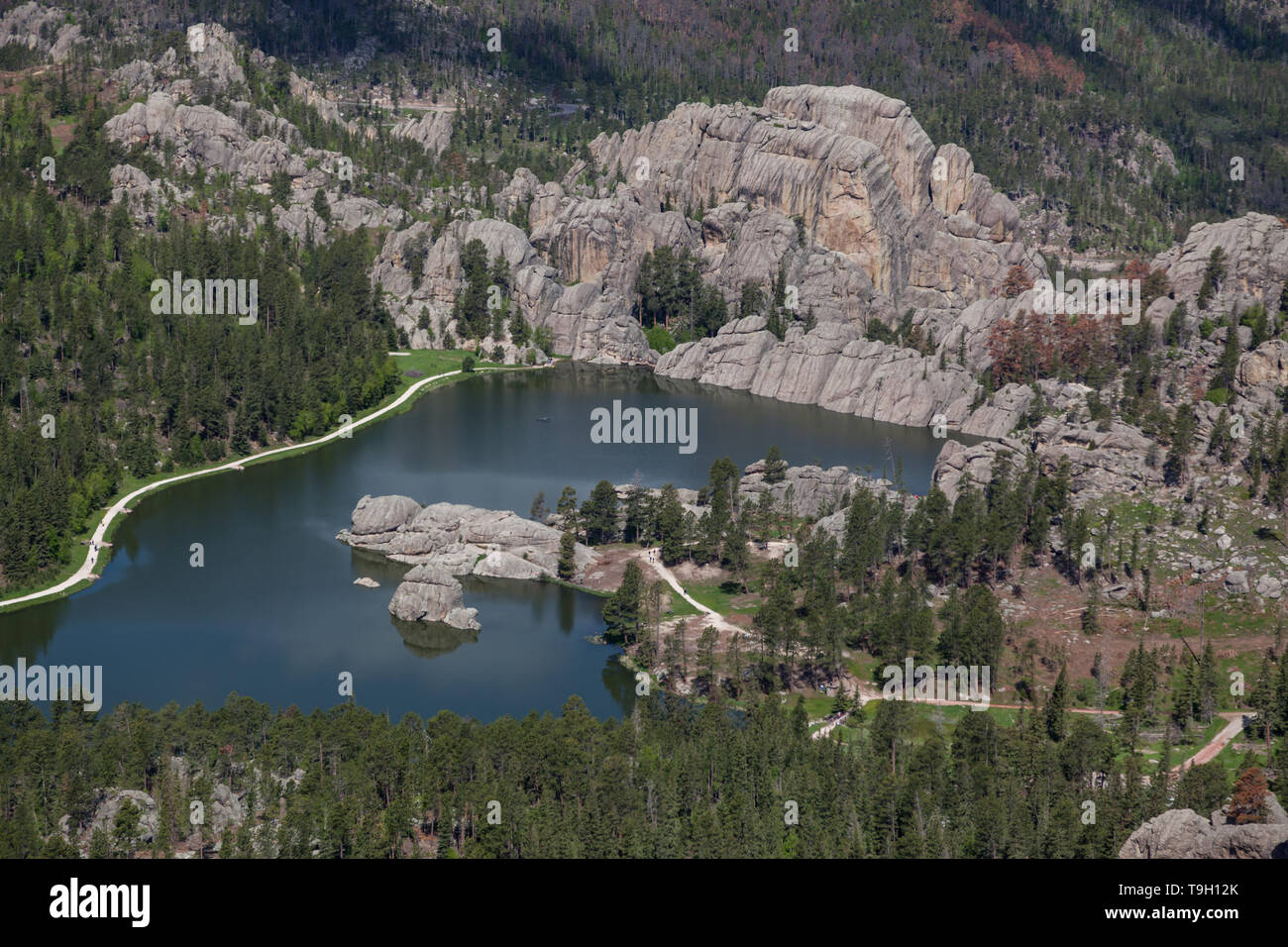 An aerial view of Sylvan Lake in South Dakota on a sunny day with large