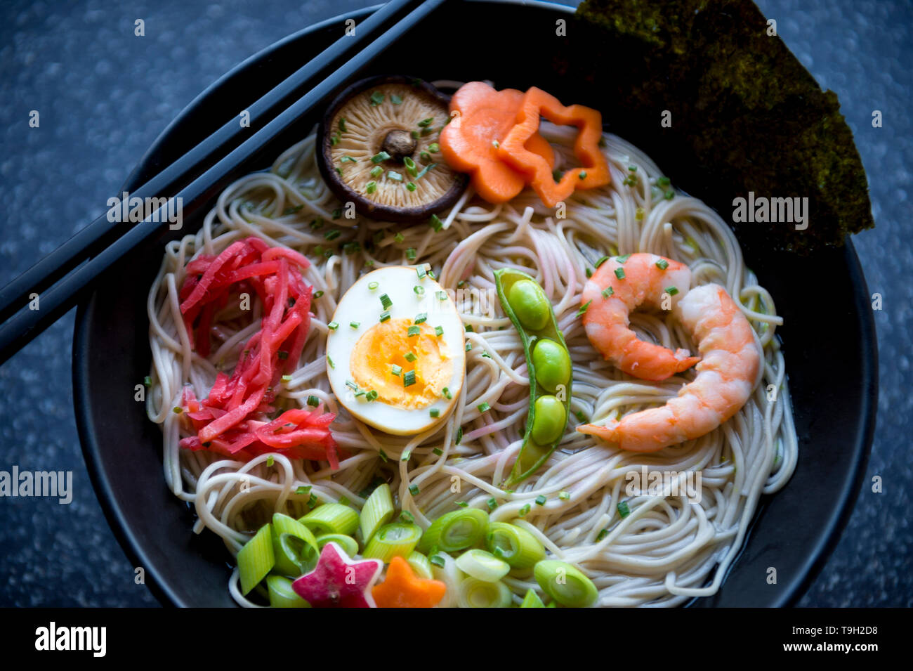 Bowl of Japanese buckwheat ramen noodle soup with colorful toppings