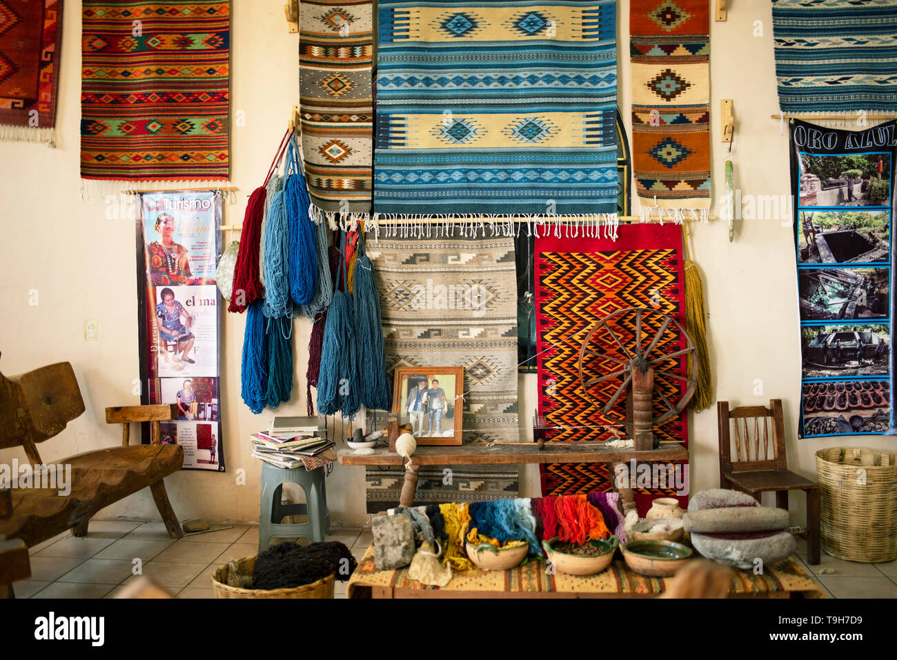 Weavers showroom of woven rugs and its process: natural dyes and a spinning mule for making woolen yarn. Teotitlan del Valle, Oaxaca, Mexico. Apr 2019 Stock Photo