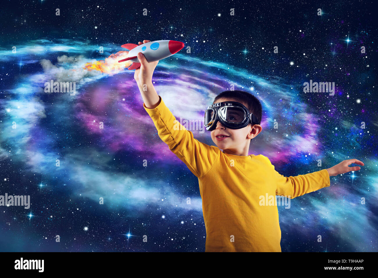 Child plays with a rocket. Concept of imagination Stock Photo
