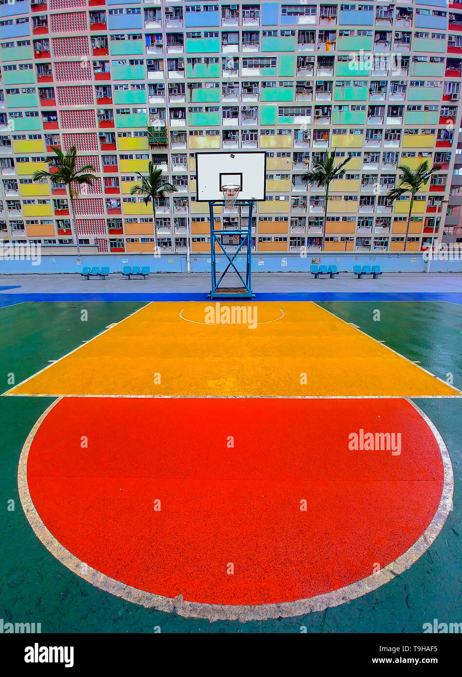 The bright colours of the basketball court and apartments of the Choi