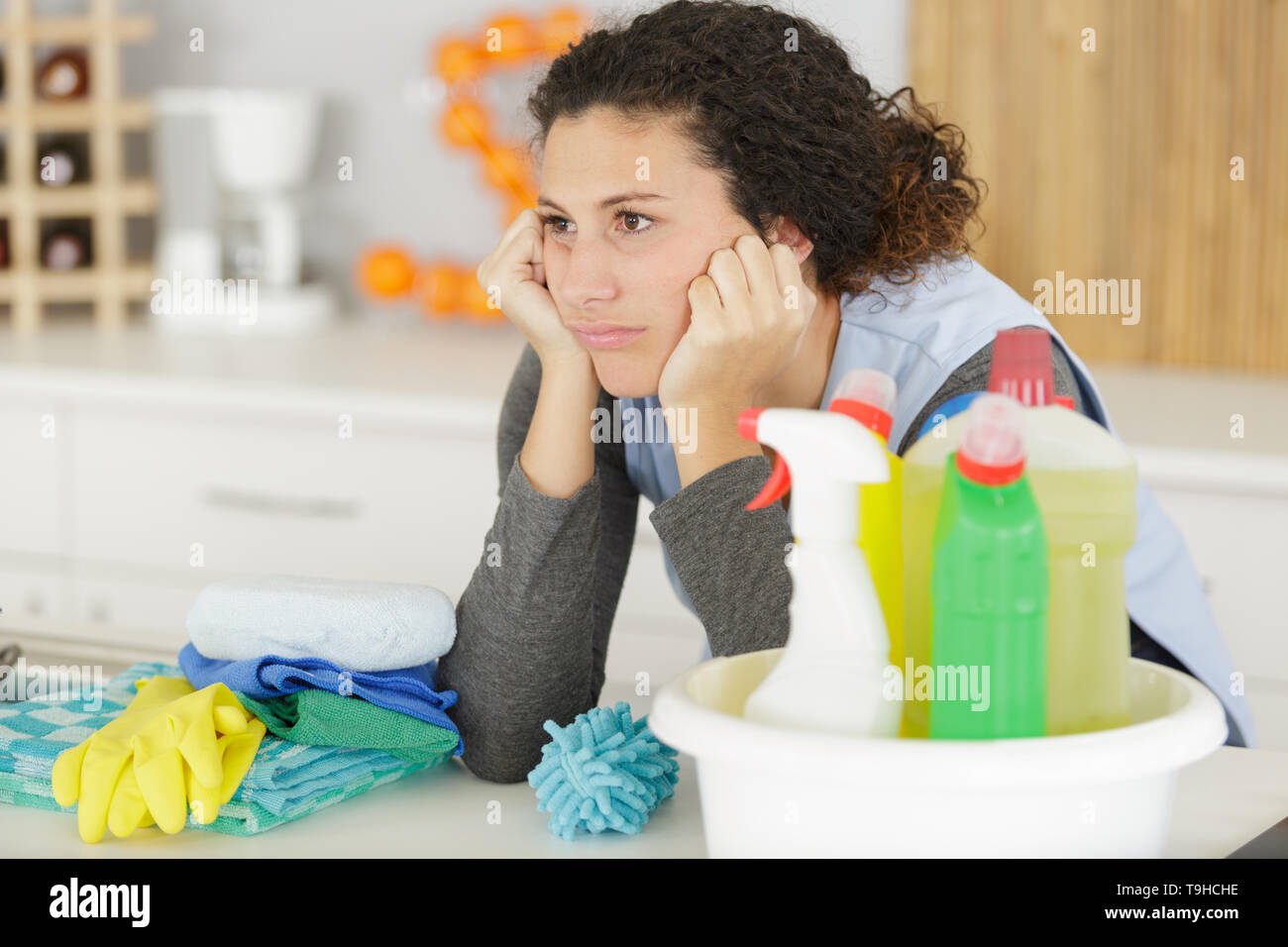 woman boring with cleaning products Stock Photo