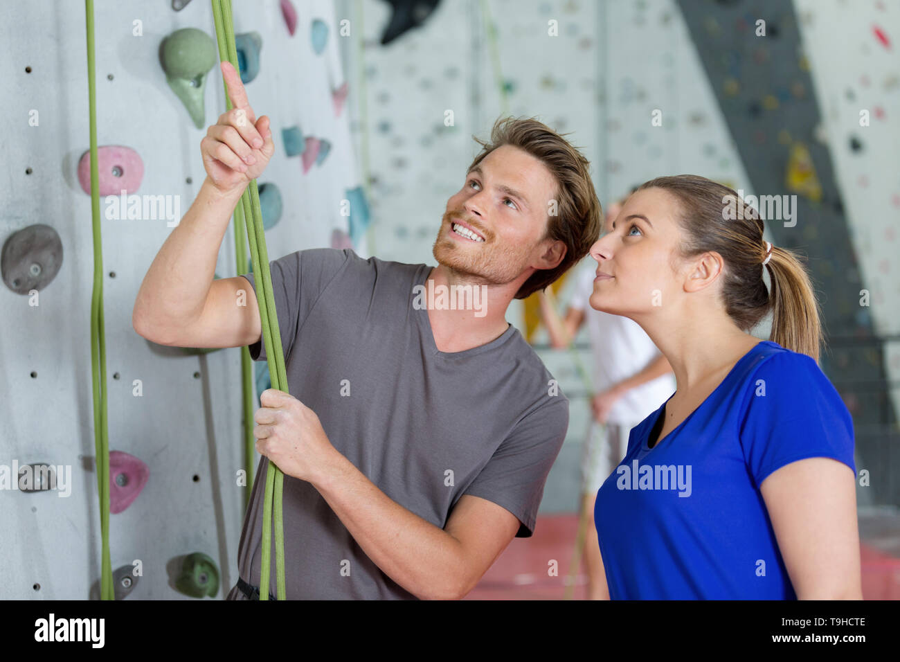 wall climbing coach explaining rules Stock Photo Alamy