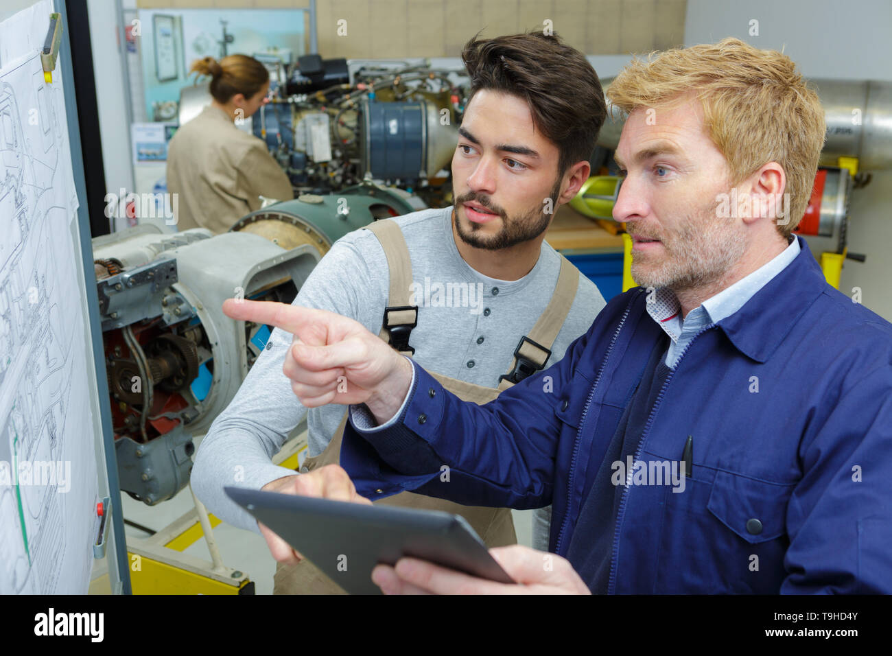 workers analyzing construction plans Stock Photo
