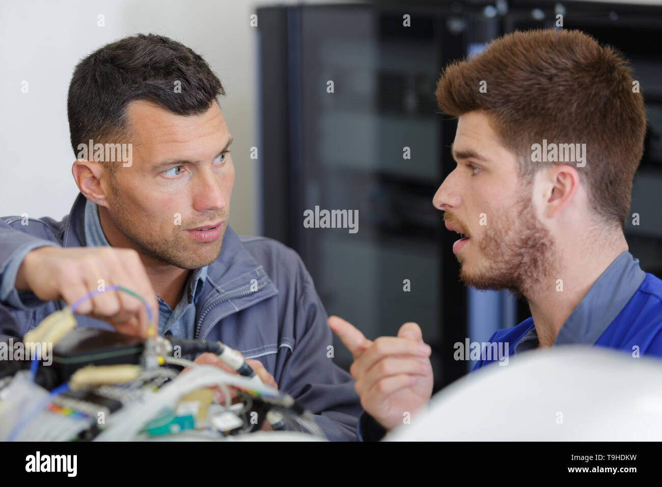 Apprentice mechanic working under hi-res stock photography and images ...
