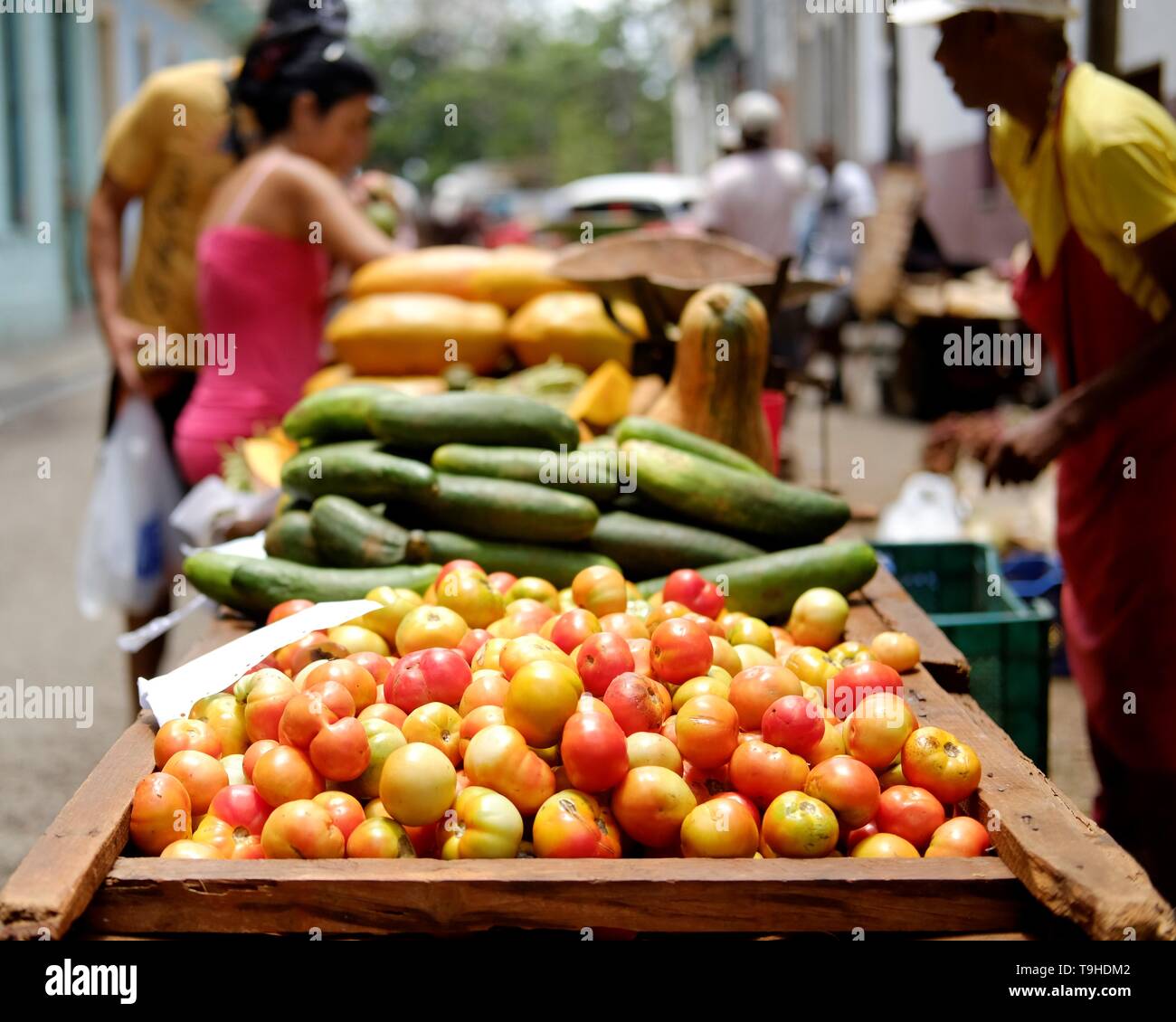 Shopping for fresh fruit and vegetables in Havana, Cuba. A vendor sells from a hand-cart, displaying colourful local produce Stock Photo