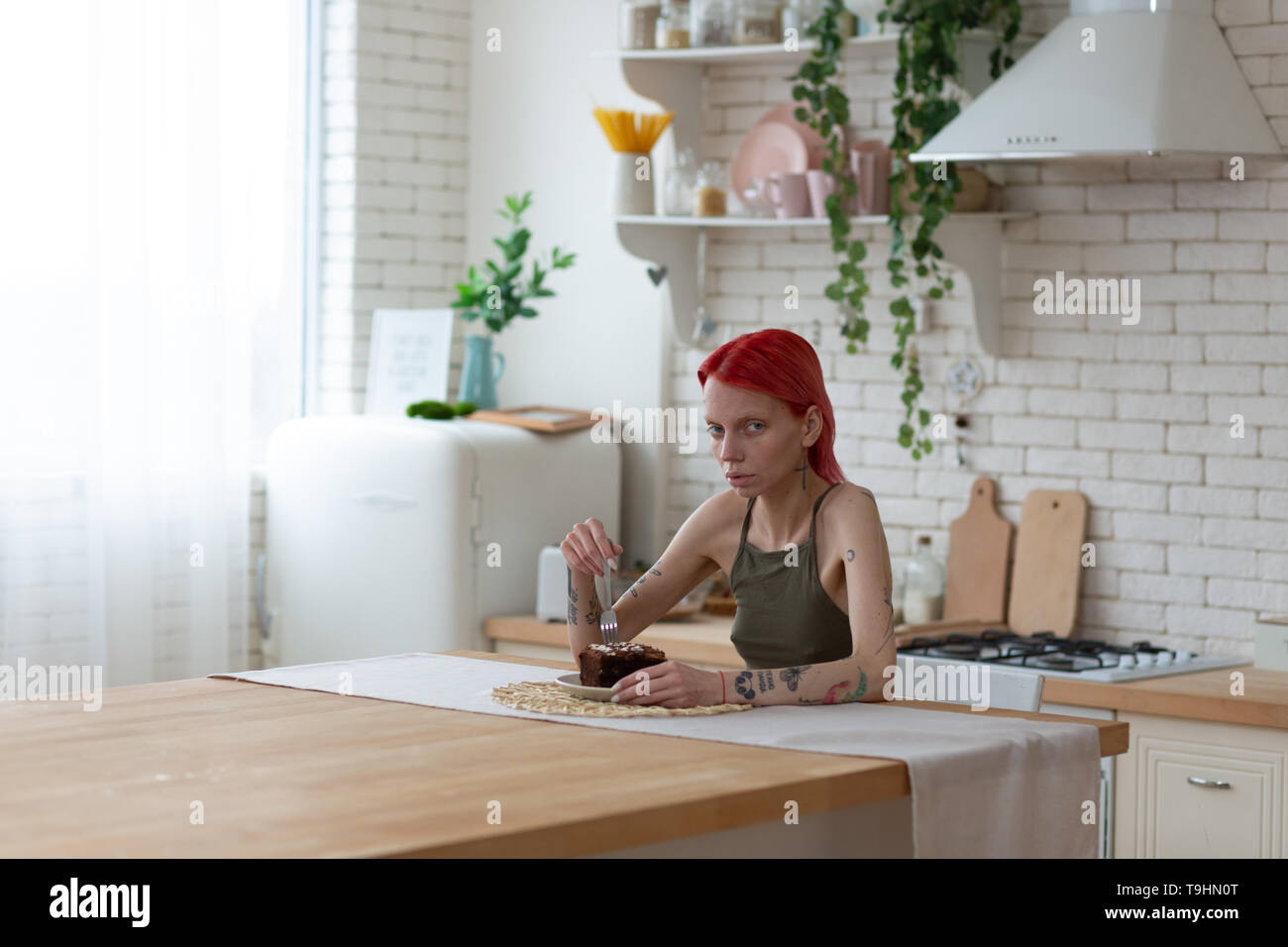 Red-haired woman looking miserable after suffering from anorexia Stock Photo