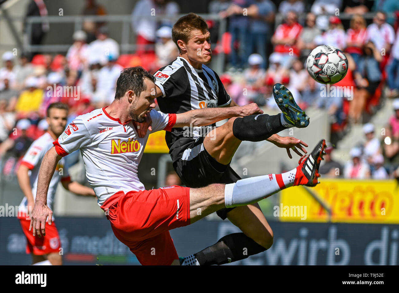 Regensburg, Germany. 19th May, 2019. Soccer: 2nd Bundesliga, Jahn Regensburg - SV Sandhausen, 34th matchday in the Continental Arena. Sebastian Nachreiner from Regensburg (l) and Kevin Behrens from Sandhausen fight for the ball. Credit: Armin Weigel/dpa - IMPORTANT NOTE: In accordance with the requirements of the DFL Deutsche Fußball Liga or the DFB Deutscher Fußball-Bund, it is prohibited to use or have used photographs taken in the stadium and/or the match in the form of sequence images and/or video-like photo sequences./dpa/Alamy Live News Stock Photo
