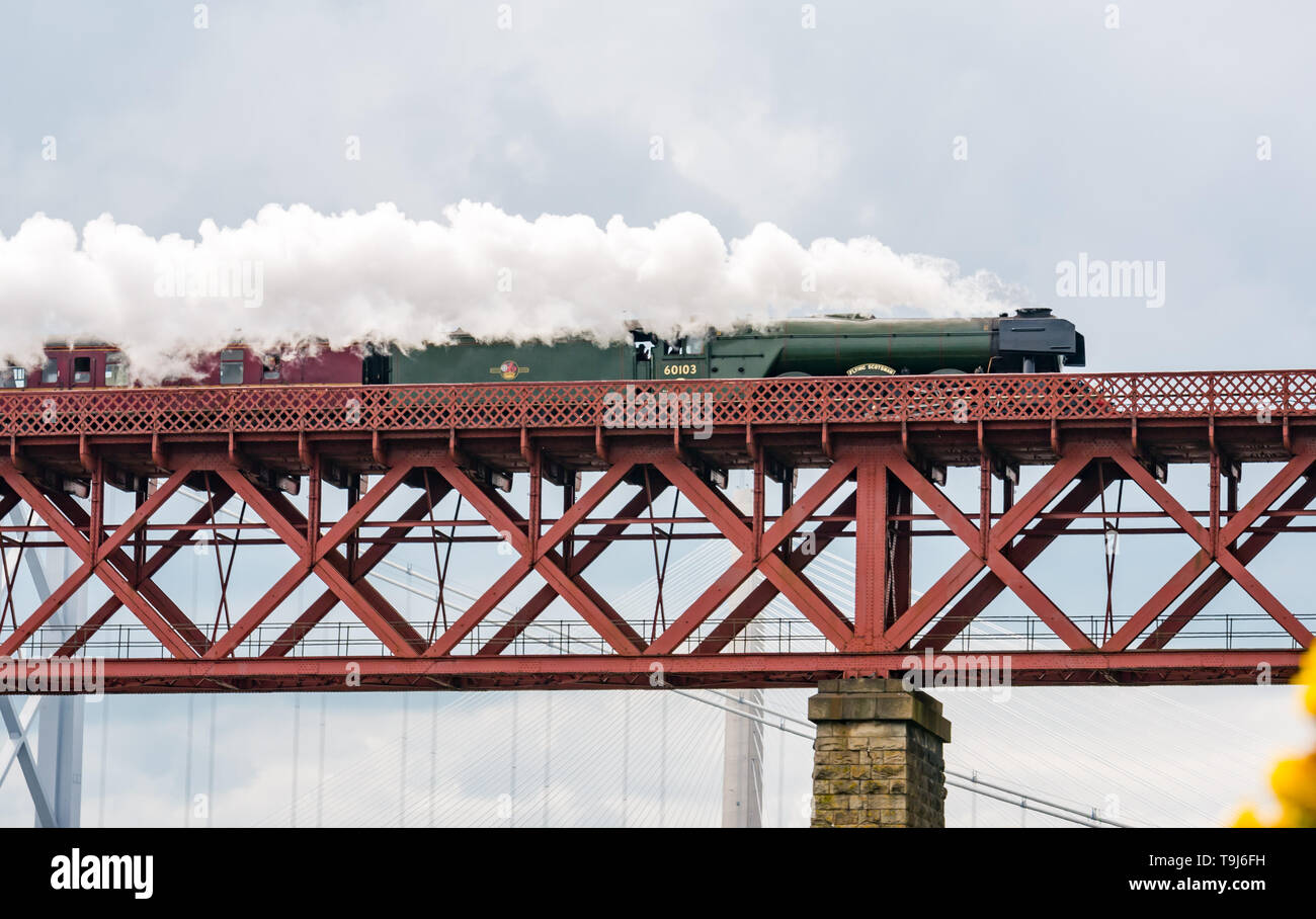 Forth Rail Bridge, North Queensferry, Fife, Scotland, United Kingdom, 19th May 2019. The Flying Scotsman steam train on tour around the Fife Circle, crossing the iconic bridge over the Firth of Forth, known simply as 'The Bridge' without needing an identification number like all other railway bridges. The steam train on its way towards Fife seen from North Queensferry Stock Photo