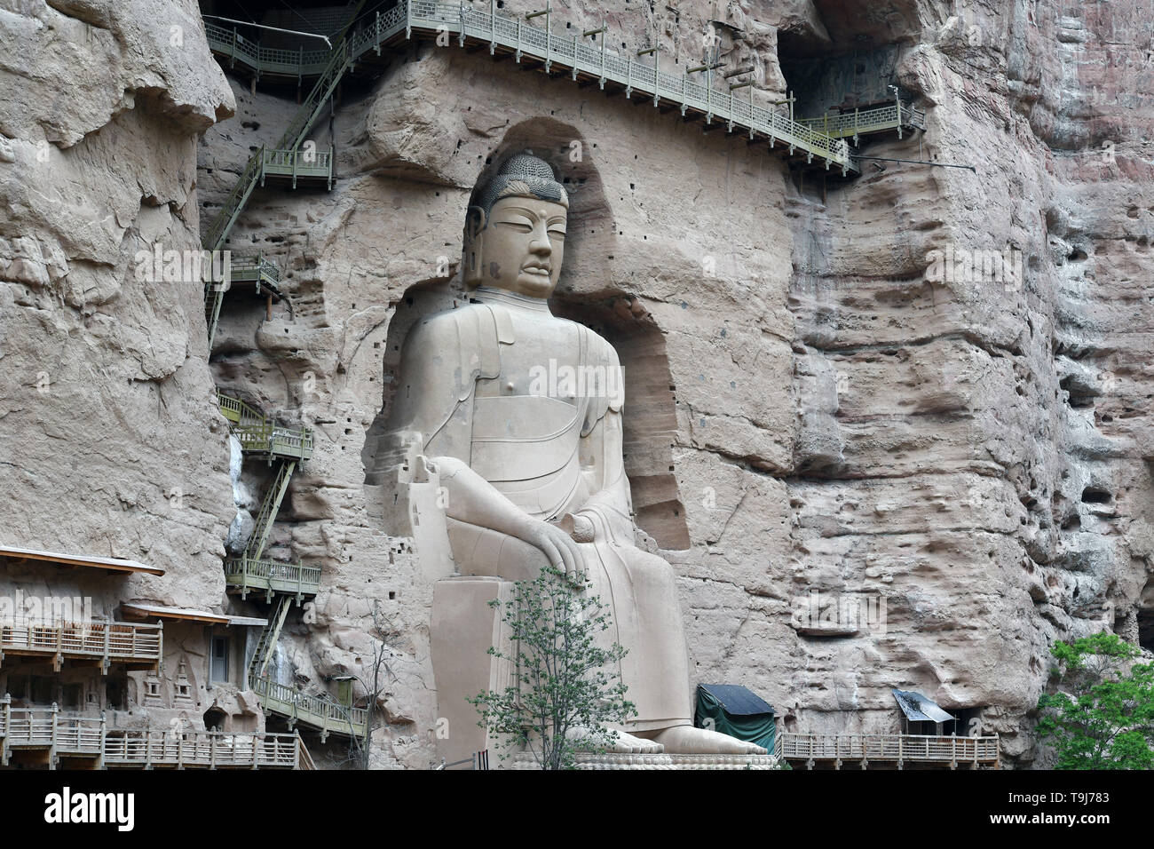 Yongjing. 18th May, 2019. A buddhist statue is shown in the photo taken on May 18, 2019 at Bingling Danxia National Geological Park in Yongjing County, northwest China's Gansu Province. Danxia landform is a unique type of landscapes formed from red sandstone and characterized by steep cliffs. Credit: Fan Peishen/Xinhua/Alamy Live News Stock Photo