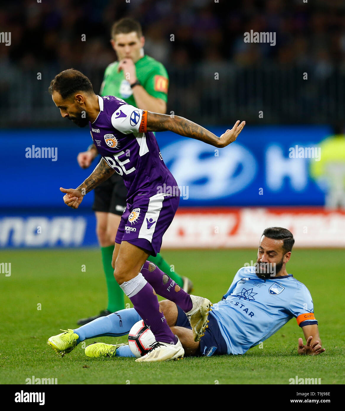 Perth Stadium, Perth, Australia. 19th May, 2019. A-League grand final, Perth Glory versus Sydney FC; Diego Castro of the Perth Glory is challenged by a sliding tackle from Alex Brusque of Sydney FC Credit: Action Plus Sports/Alamy Live News Stock Photo