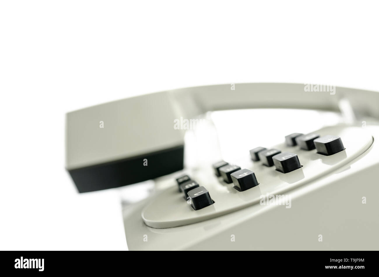 Side view of old telephone keypad and receiver. Empty space ready for