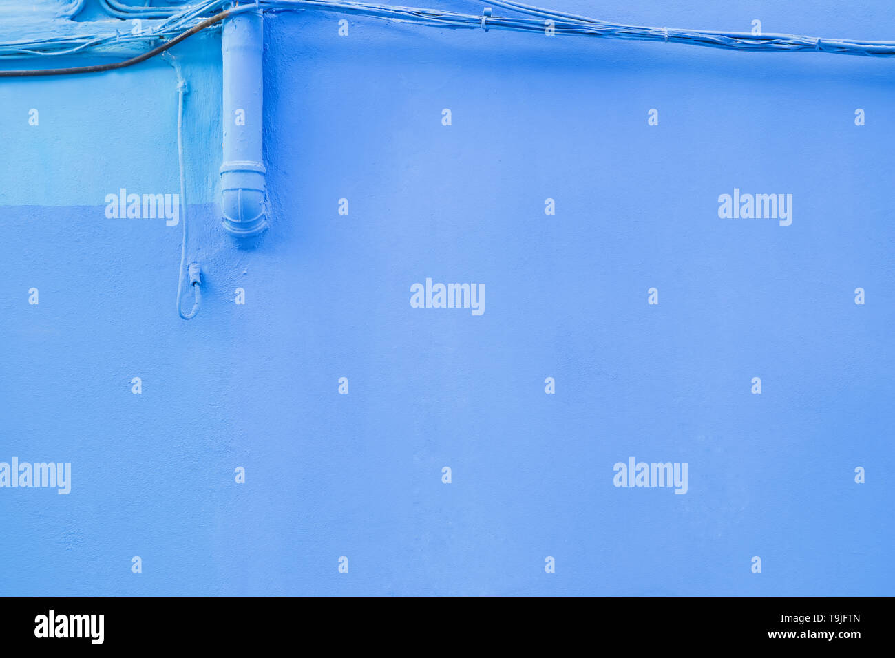 Bright blue colored wall of the building close-up Stock Photo