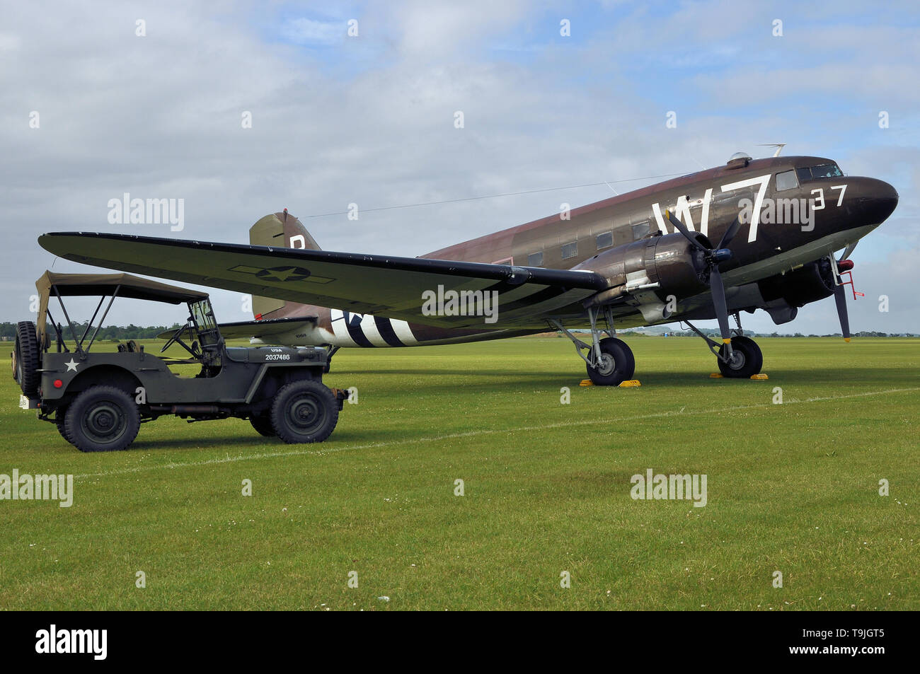 Douglas C-47 Skytrain transport plane in period camouflage markings - including D Day 'invasion stripes' - with Willys MB Jeep. Whiskey seven Stock Photo