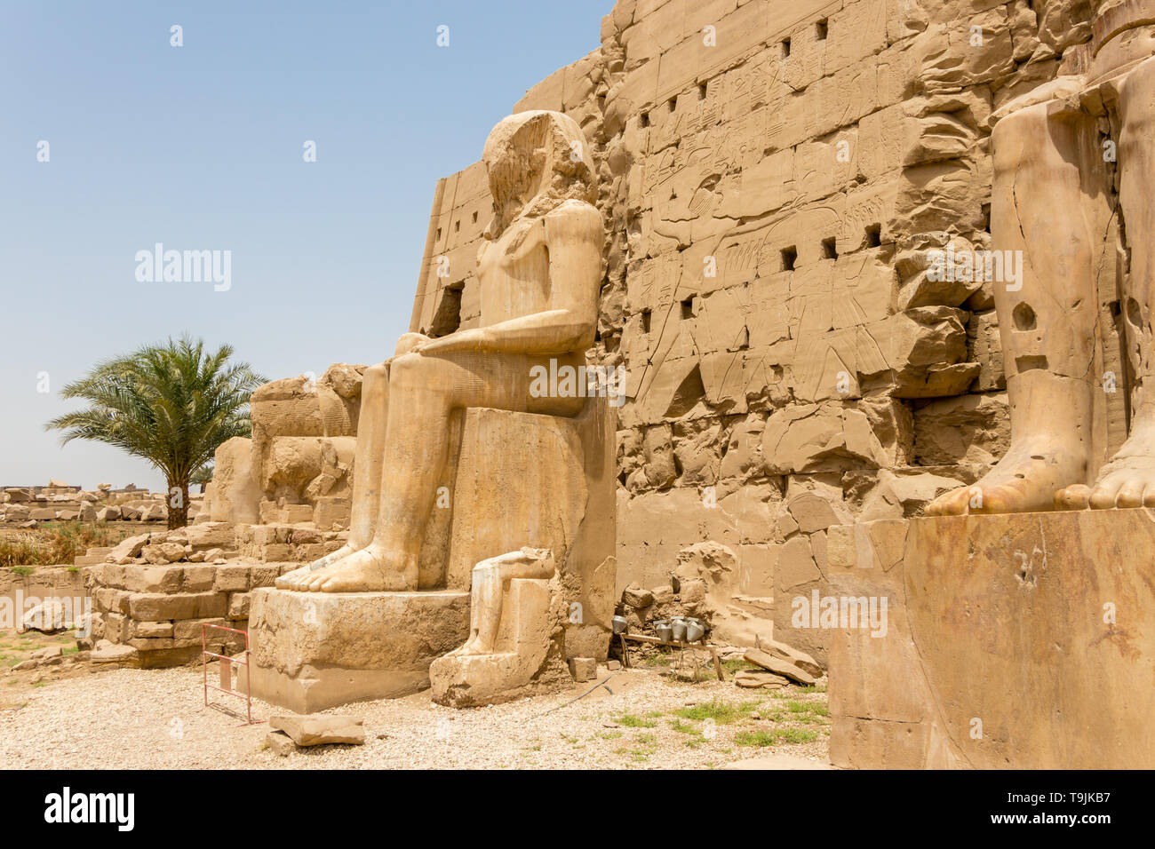 Seated statue in front of the seventh Pylon of the Karnak Temple, Luxor ...
