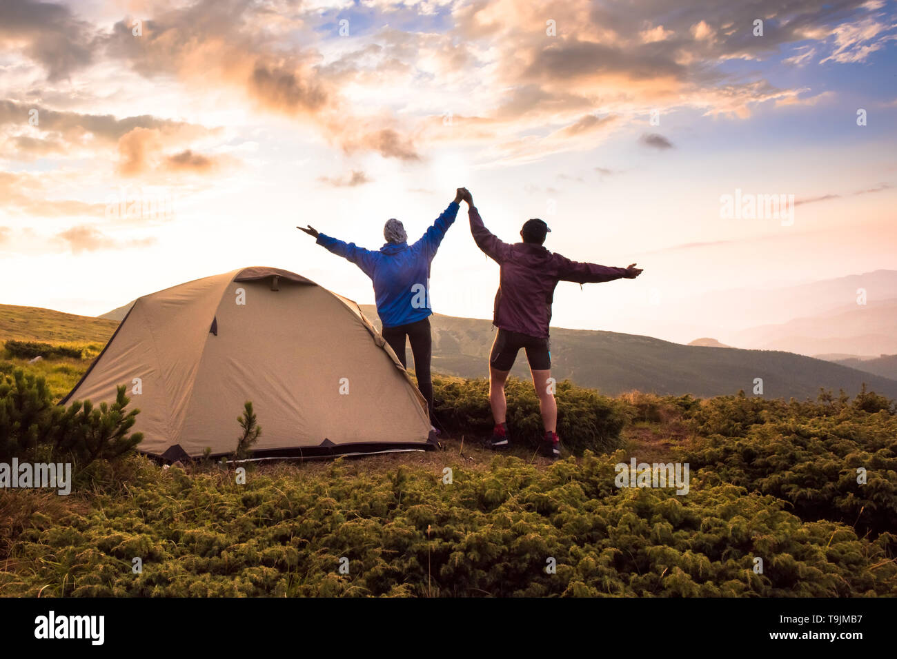 Camping and active couple on the top of high mountains. Success, Achievement, Active life style. Tatras, Zakopane, Poland Stock Photo