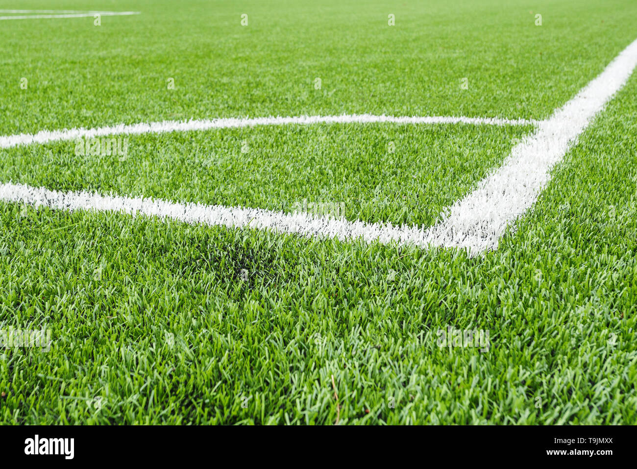 Marking the angle of the football field with artificial surface. Stock Photo