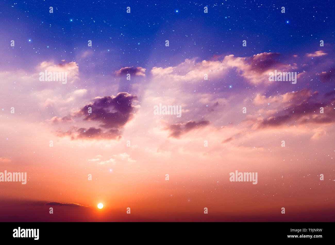 Sunset with sun, clouds and light rays. With stars on background. Stock Photo