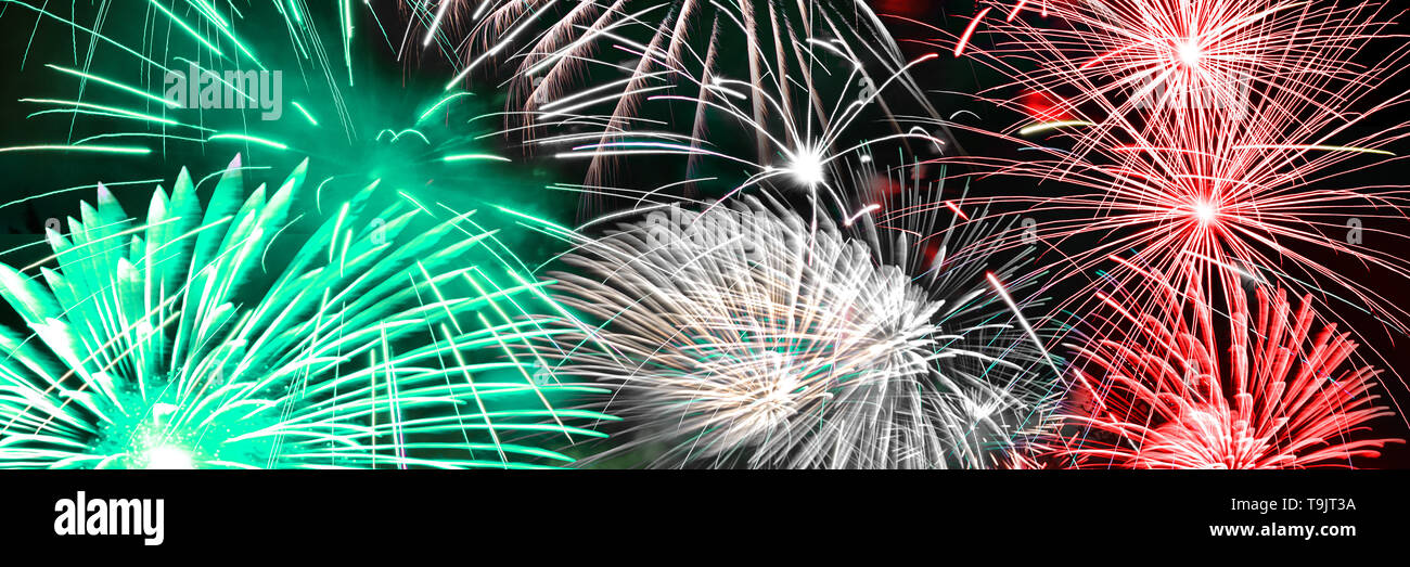 Green white and red fireworks panoramic background Stock Photo