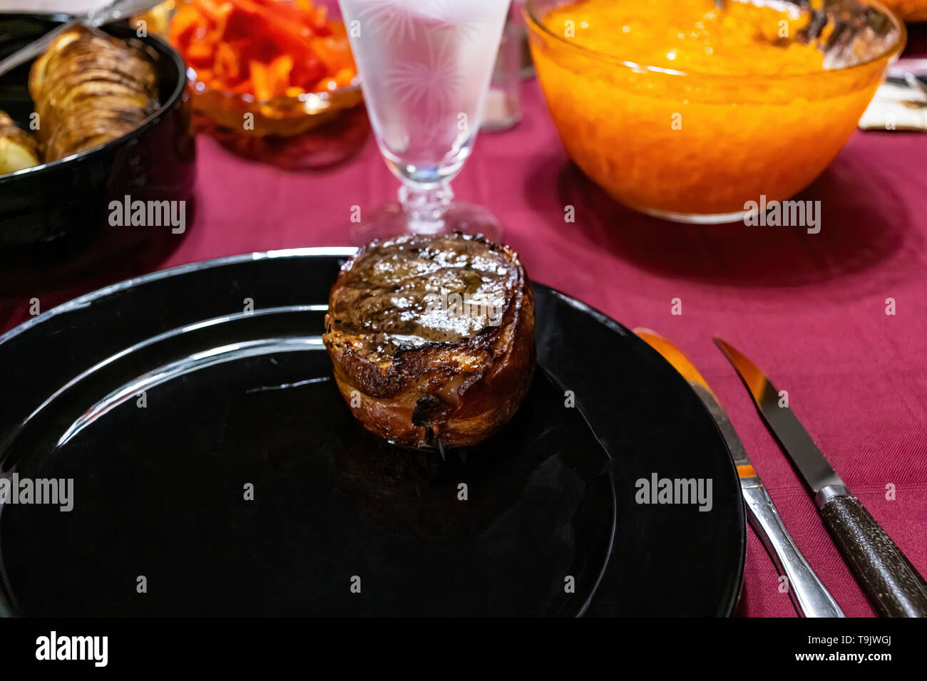 a grilled filet mignon steak on a plate waiting for dinner Stock Photo