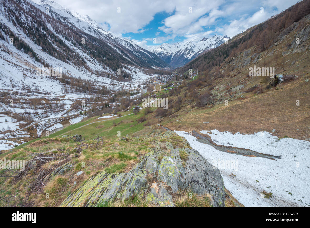 Lonesome mountain valley in the Bernese Alps, Switzerland. Snowcapped mountains, mountain valley viewed from high above on the slopes. Stock Photo