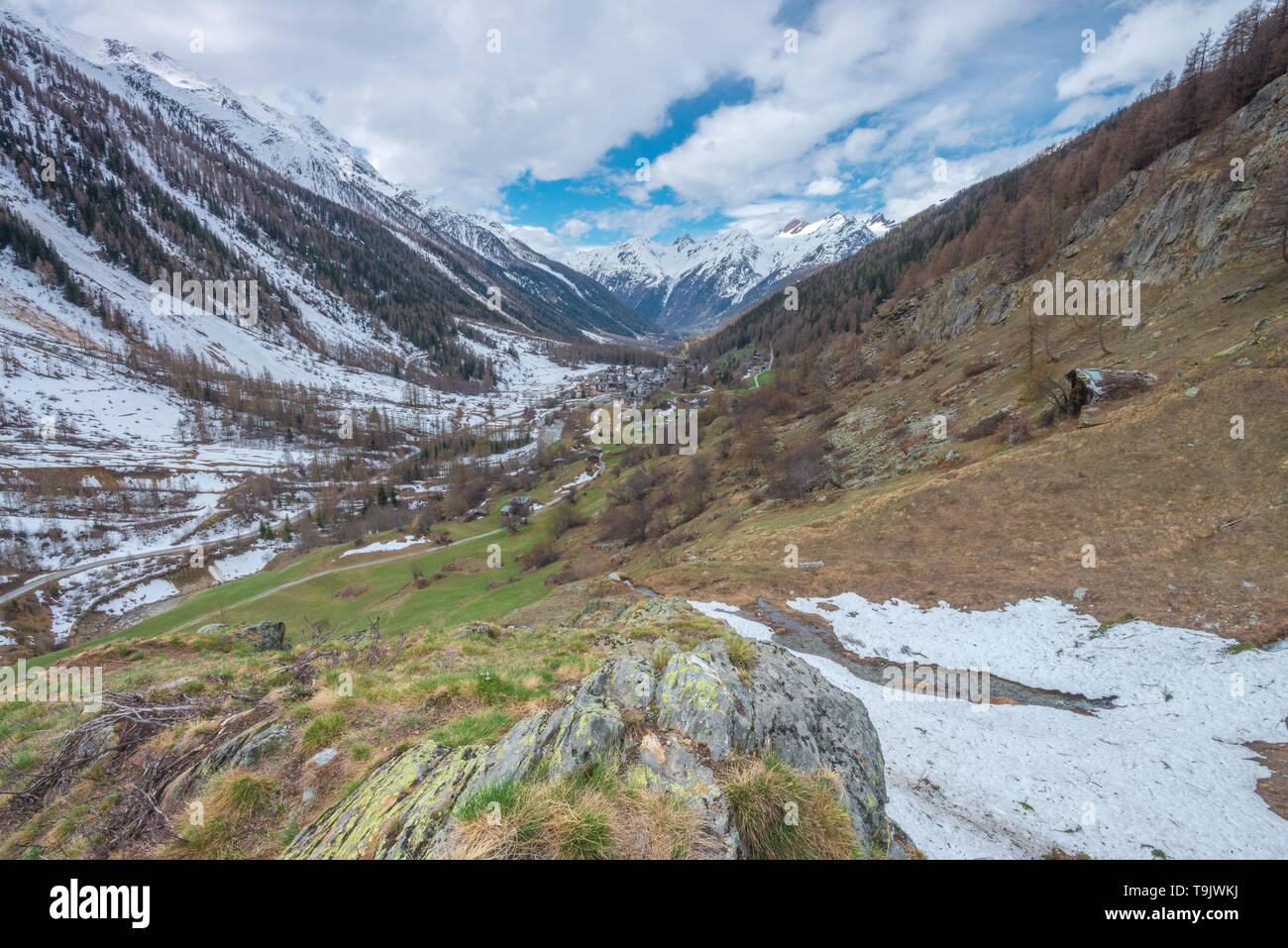 Lonesome mountain valley in the Bernese Alps, Switzerland. Snowcapped mountains, mountain valley viewed from high above on the slopes. Stock Photo