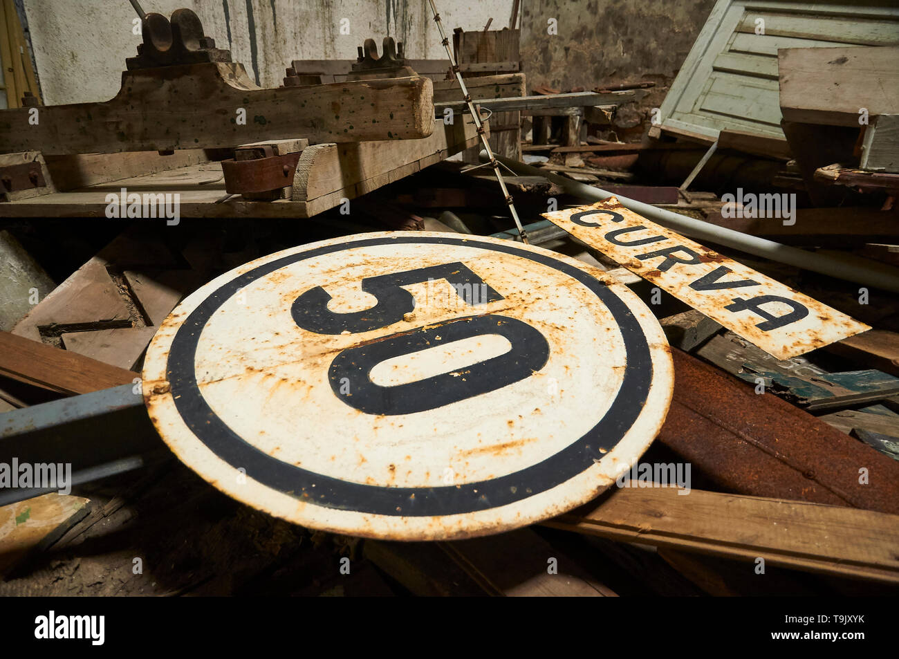 Old speed warning signal thrown in neglected facilities at Canfranc International railway station (Canfranc, Pyrenees, Huesca, Aragon, Spain) Stock Photo