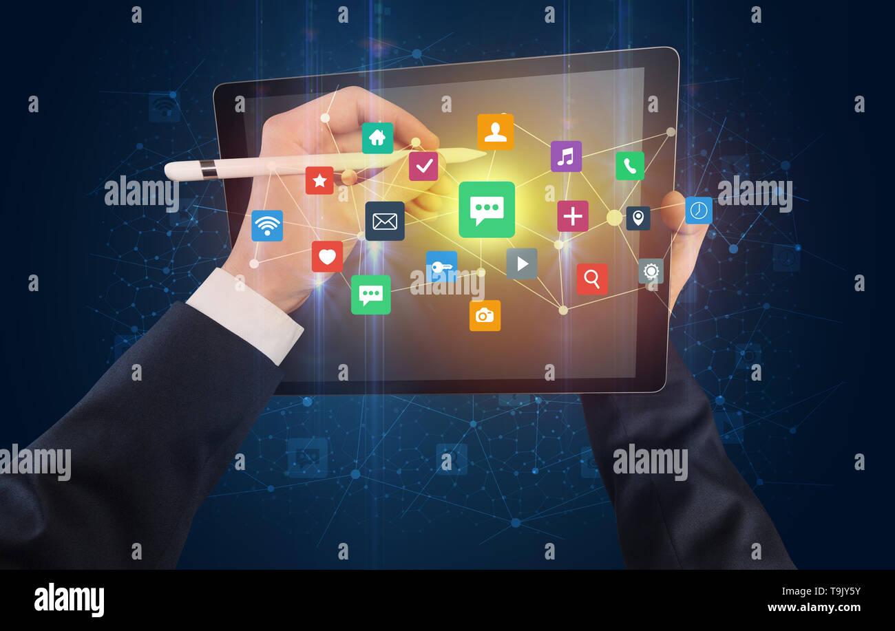 Hand using tablet with colorful bounce application symbols and icons ...