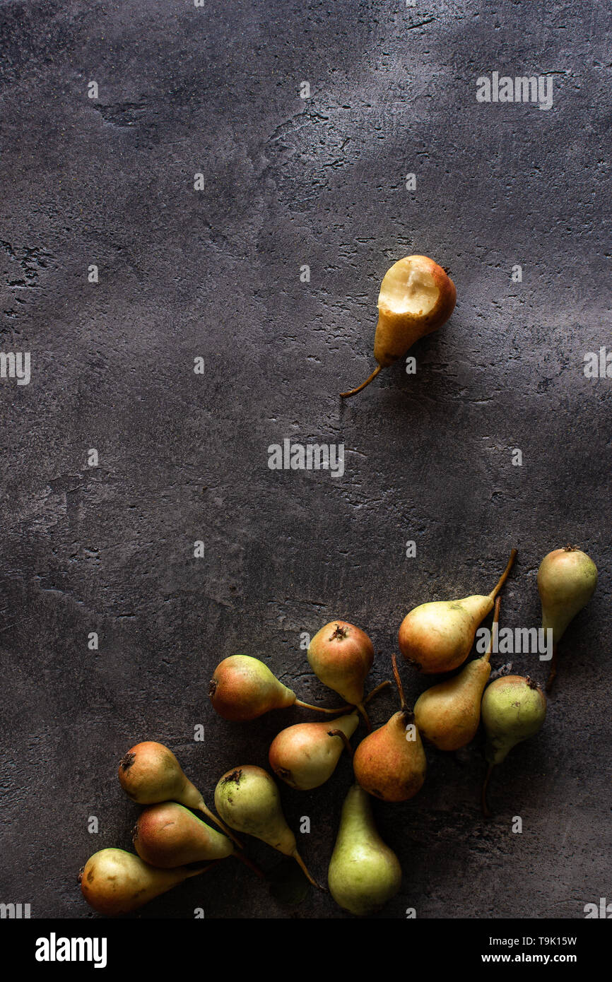 Organic Yellow Pears on Rustic Dark Background with Copy Space. Detox Therapy. Stock Photo