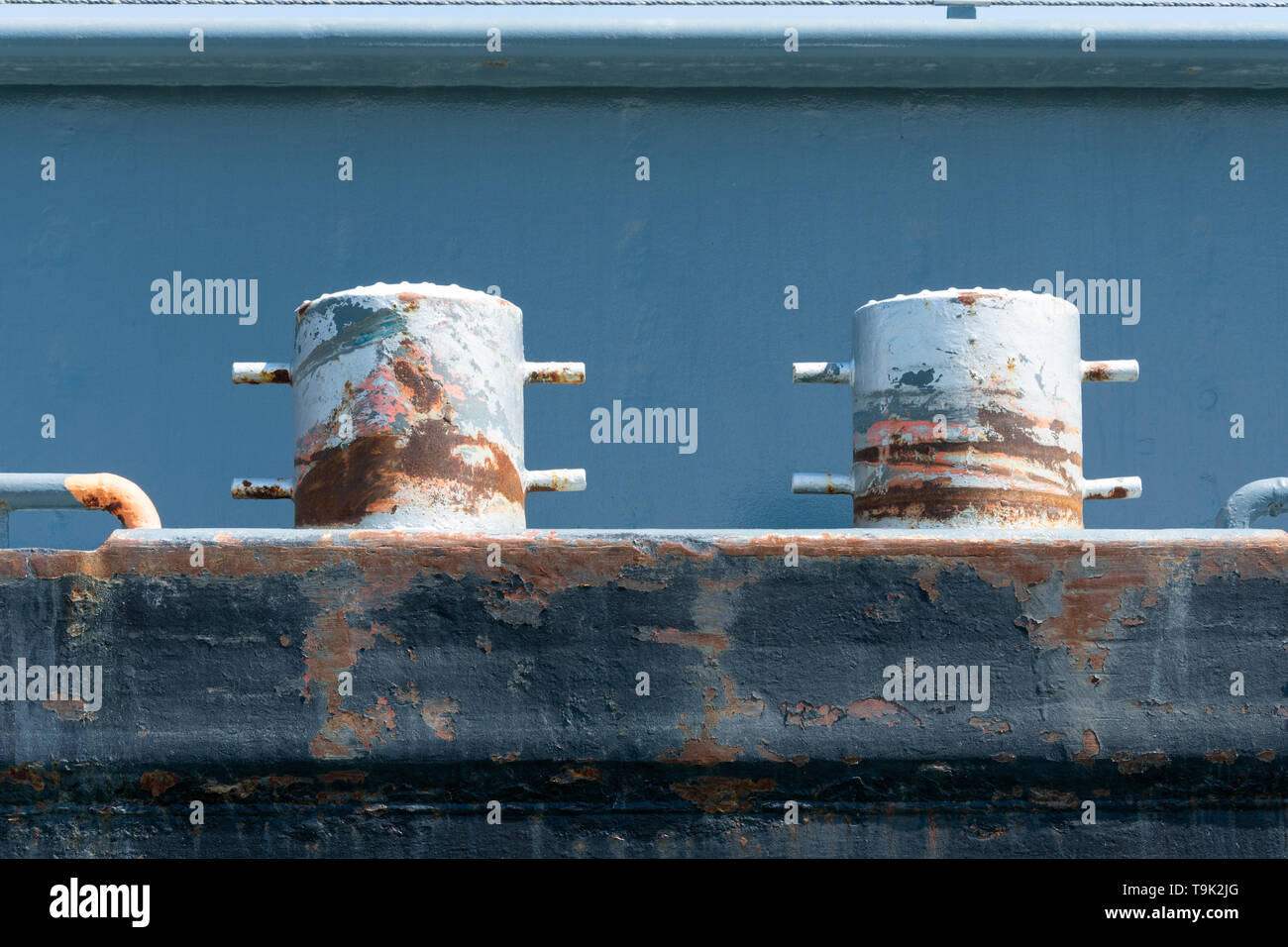 Two rusty bollards on the edge of a ship Stock Photo
