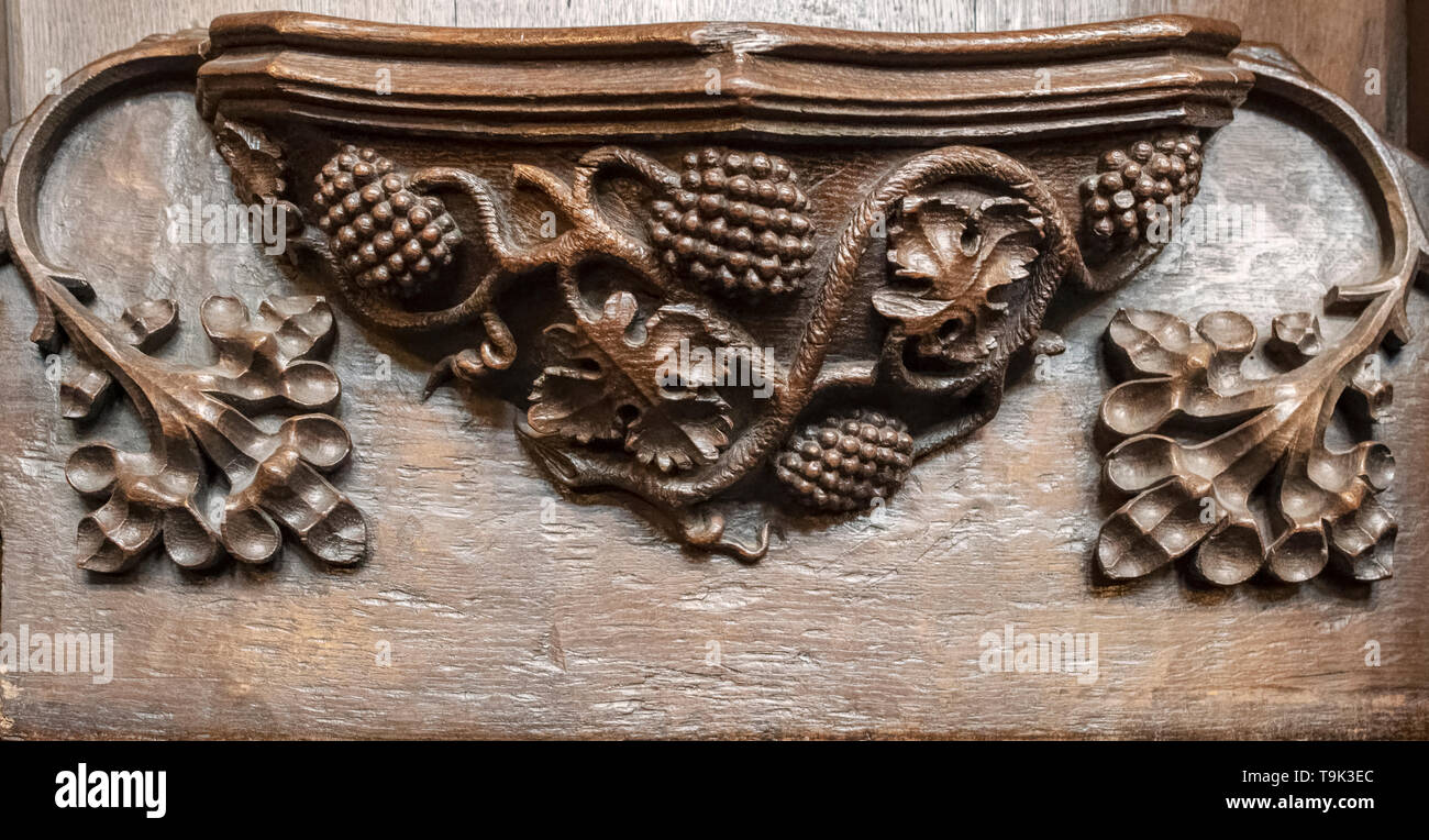 A medieval misericord depicting a vine with four bunches of grapes, Ripon Cathedral, Yorkshire, UK Stock Photo