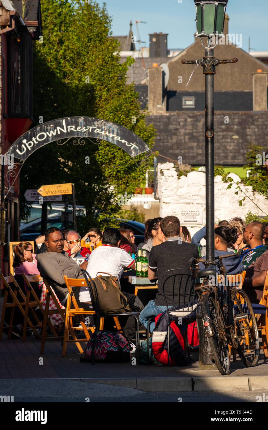 People dining alfresco outside a bar restaurant at the Old Market Lane in Killarney, County Kerry, Ireland Stock Photo