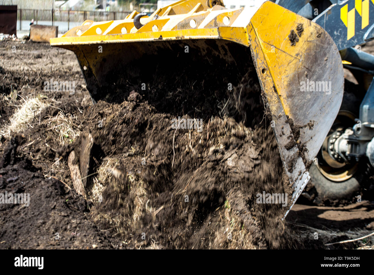 bulldozer pushes the ground, tractor pushes a lump of soil, preparing