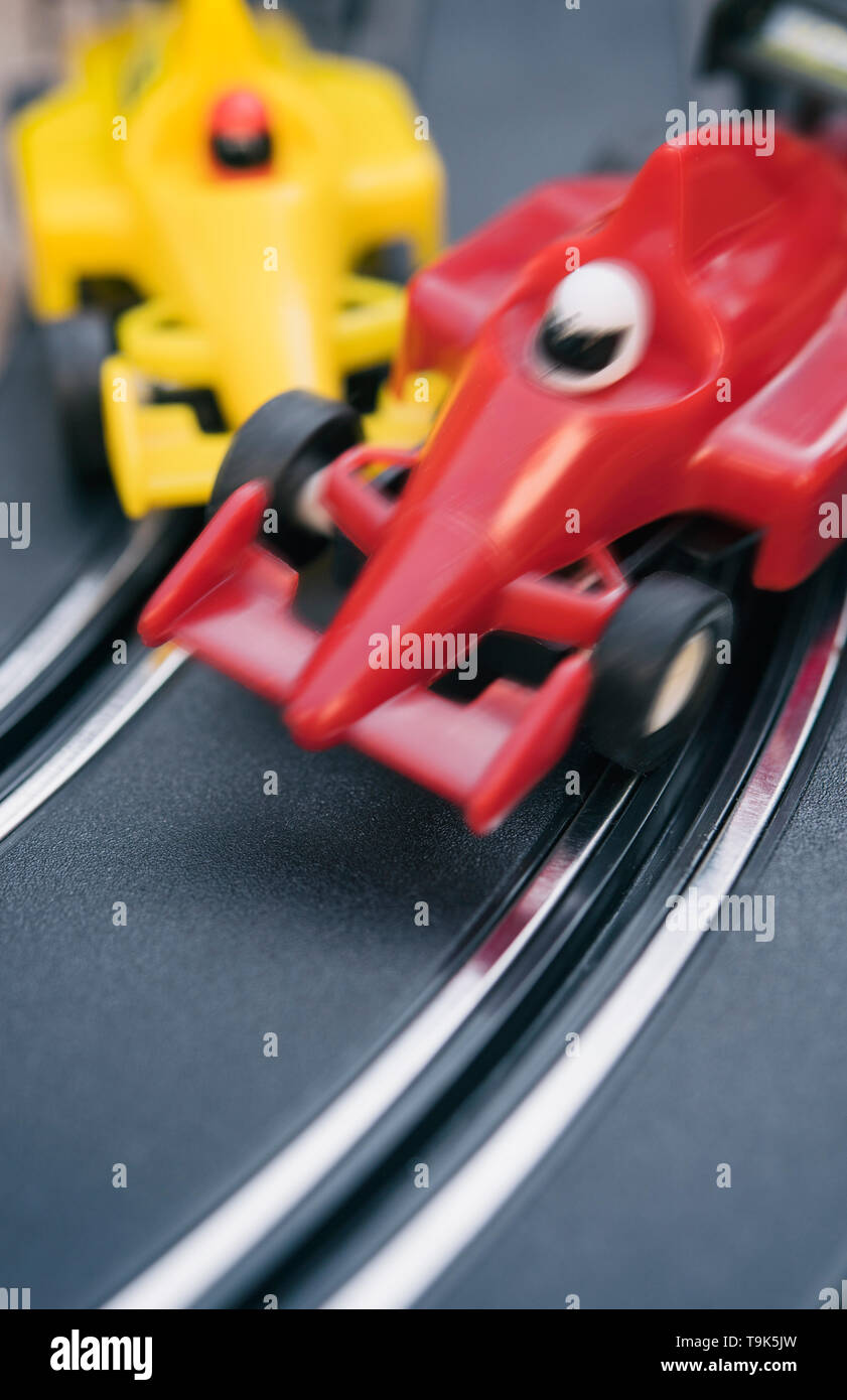 Toy cars colliding on a slot car race track Stock Photo