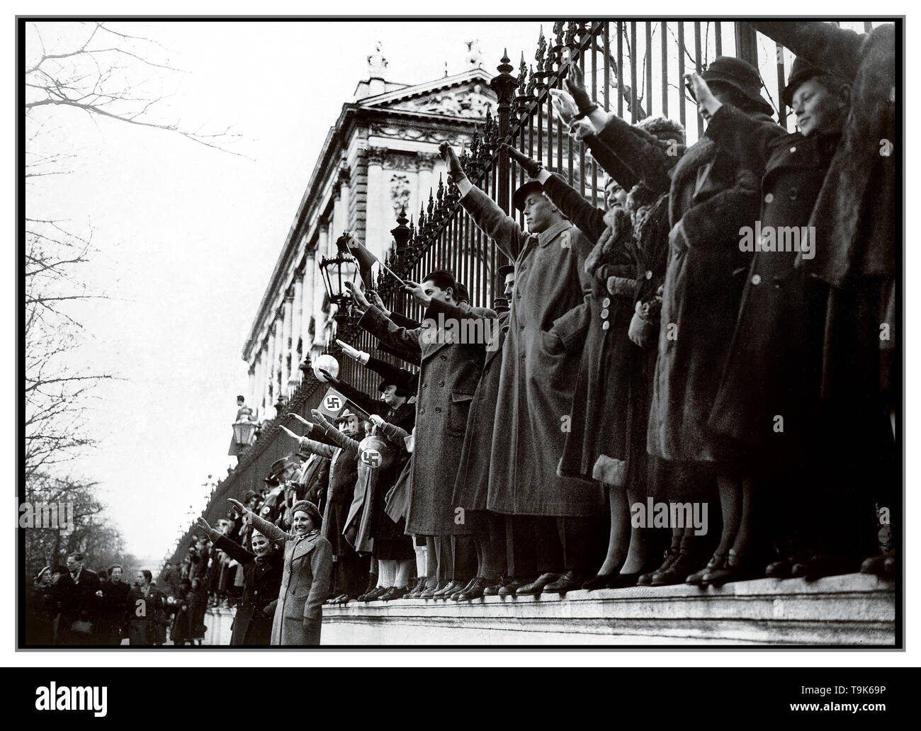Archive 1938 B&W Propaganda image ”Anschluss'  Groups of Austrians waving swastika flags and saluting Heil Hitler greet the Nazi German forces annexation & occupation of Austria.  Anschluss refers to the annexation of Austria into Nazi Germany on 12 March 1938. The German spelling was Anschluß and it was also known as the Anschluss Österreichs Stock Photo