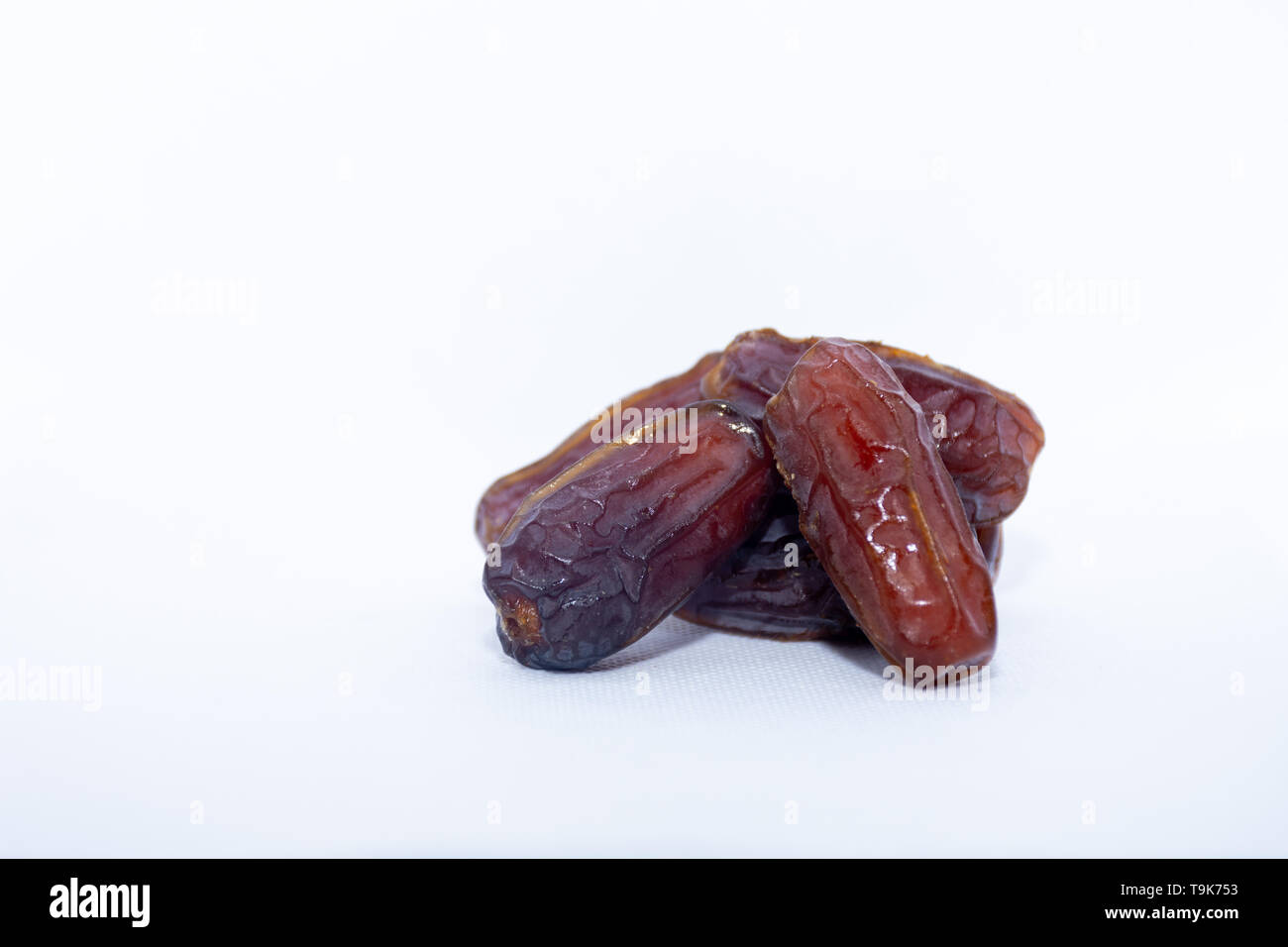 A group of medjool dates bottom right from Saudi Arabia on an isolated ...