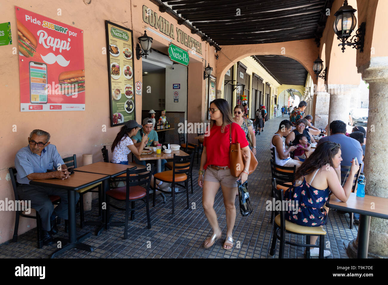 Mexico cafe: tourists and local mexican people mix in a street scene at a cafe, Plaza Grande, Merida Yucatan Mexico Central America - mexico lifestyle Stock Photo