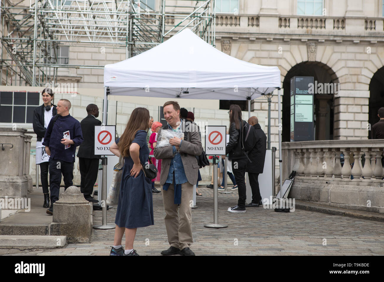 London, UK. 18 May 2019. (L-R) A visitor talks to photographer Richard Billingham at the fifth edition of Photo London at Somerset House. Over 100 galleries from 24 different countries showcase the work of past, present and future leading artists in photography. A Master of Photography exhibition dedicated to US photographer Stephen Shore.  An installation takes the theme of Women in Photography, celebrating the work of three established women photographers – Rachel L. Brown, Mary McCartney and Susan Meiselas. A discovery section focus on new and emerging talent. Stock Photo