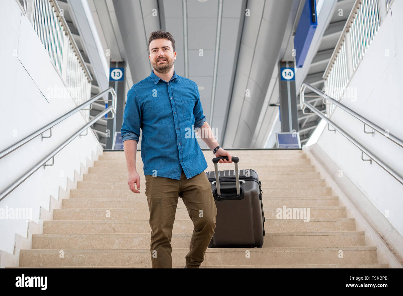 Man carrying heavy bags hires stock photography and images Alamy
