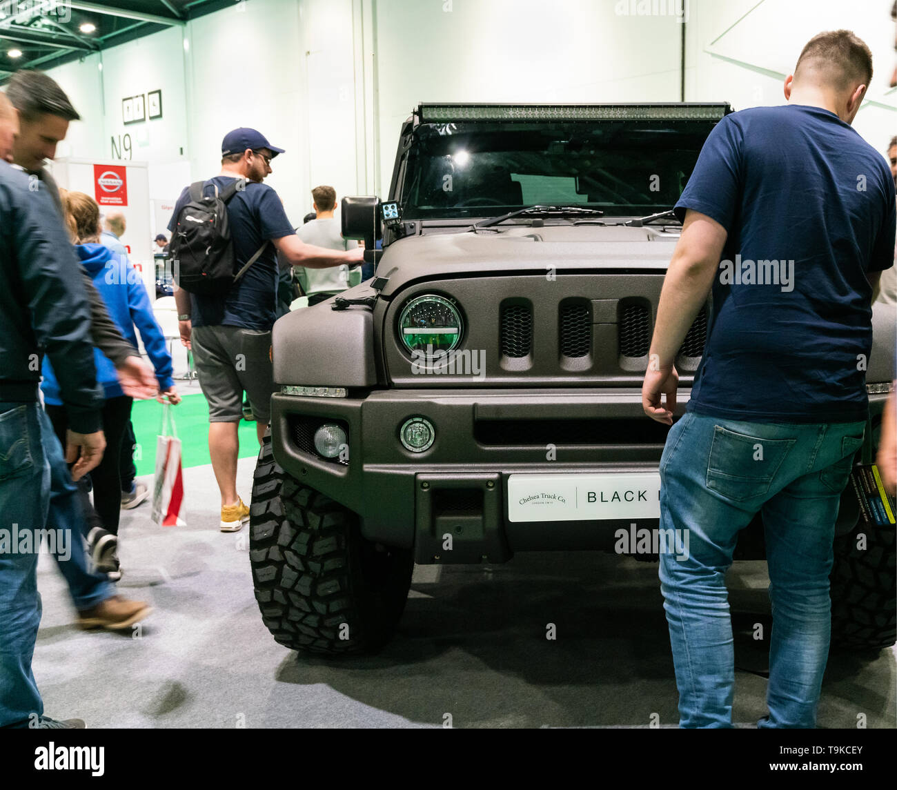 18th May 2019. London, UK. Men showing interest in Wrangler Jeep Black Hawk Wide Body edition at London Motor Show 2019 Stock Photo