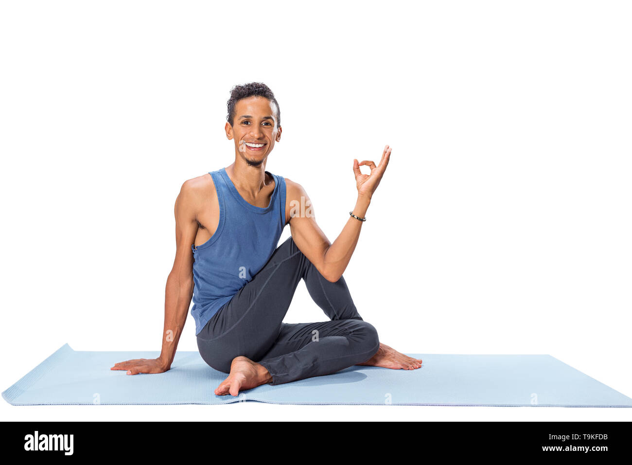 Young man doing yoga asana poses exercise studio photo isolated on white background Stock Photo