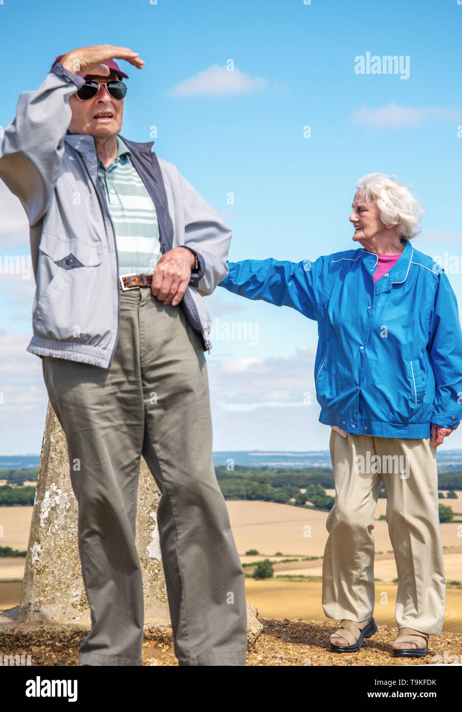 90 year old man takes his wife,who has severe sight loss to the countryside in Wiltshire to get her out in nature and away from their house. Stock Photo