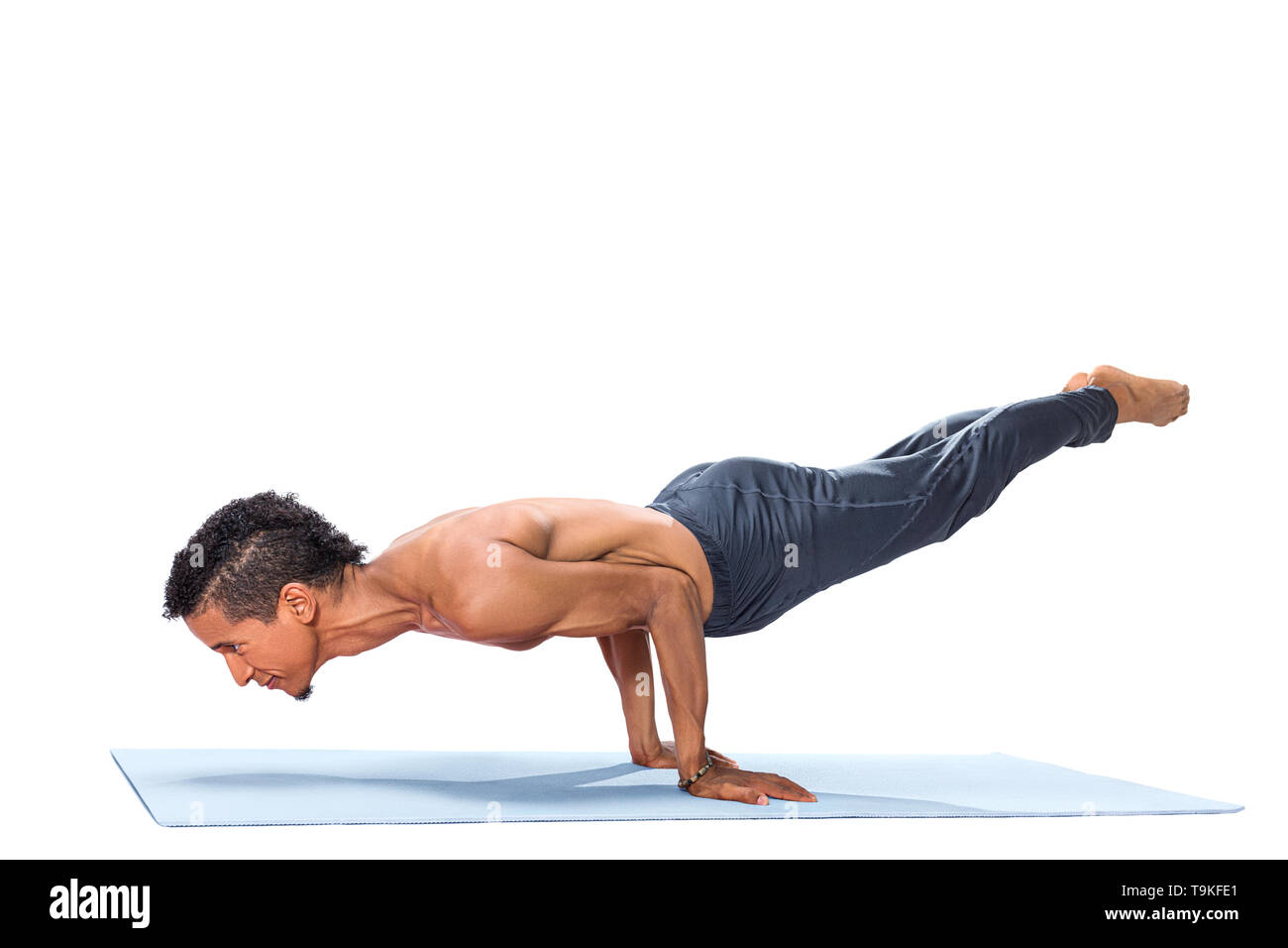Young man doing yoga asana poses exercise studio photo isolated on white background Stock Photo